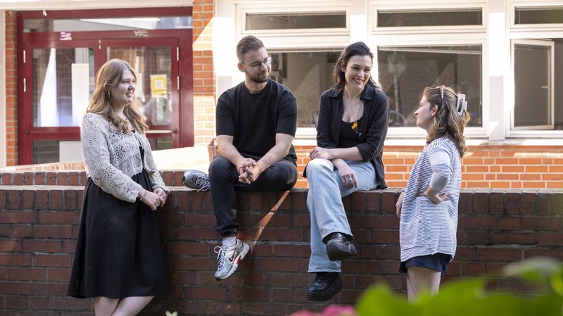 Vier Studierende vor der Evangelischen Hochschule.