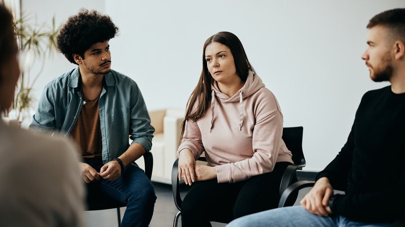 Drei Personen in einer Selbsthilfegruppe